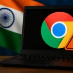 A black laptop displays the Google Chrome logo with an orange warning symbol, set against a wooden table and the blurred Indian flag in the background — indicating a browser-related security alert.