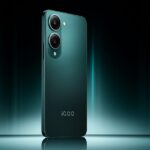 iQOO Z10 Lite 5G in Cyber Green color variant standing upright on a dark teal background, showcasing its sleek matte finish and dual-camera setup