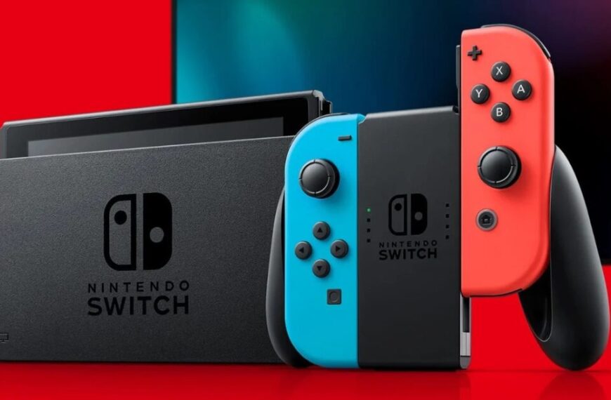 Official Nintendo Switch console with red and blue Joy-Con controllers docked for TV mode on a red and black background.