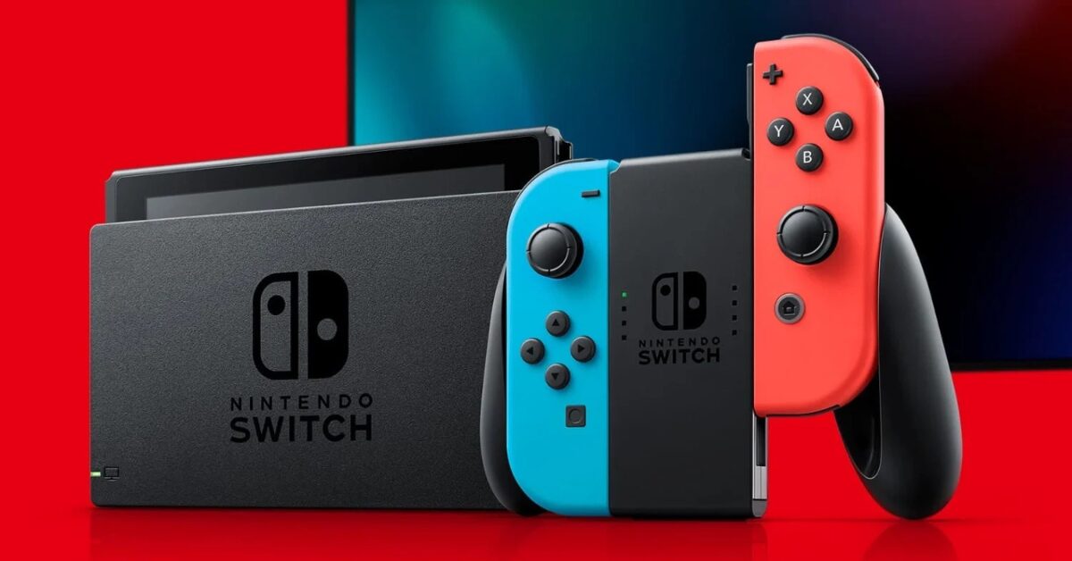 Official Nintendo Switch console with red and blue Joy-Con controllers docked for TV mode on a red and black background.