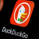 Close-up of DuckDuckGo app icon on smartphone screen under a fingertip