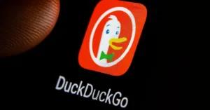 Close-up of DuckDuckGo app icon on smartphone screen under a fingertip